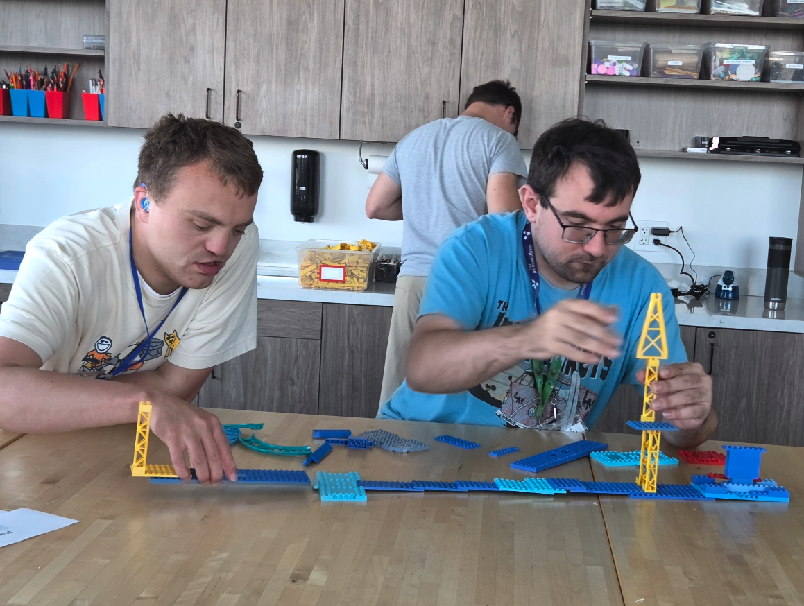 Two male students at Journey21 building with LEGO